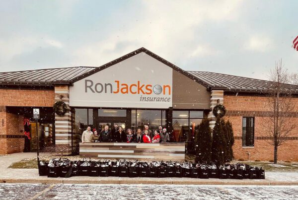 Quotes for a Cause - Past Recipients - Group Photo of the Ron Jackson Insurance Team in Front of Large Office Building
