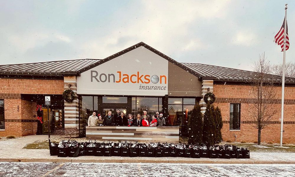Quotes for a Cause - Past Recipients - Group Photo of the Ron Jackson Insurance Team in Front of Large Office Building